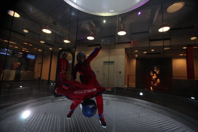 Michelle flying in the wind tunnel as an instructor at iFly Dallas.