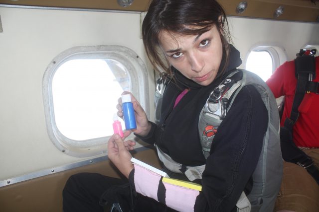 Michelle poses on the plane with paints in hand. Her first jump with paint!