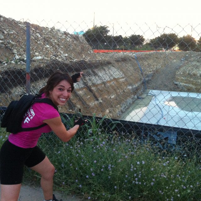 Michelle excitedly points at the construction site for iFly Dallas.