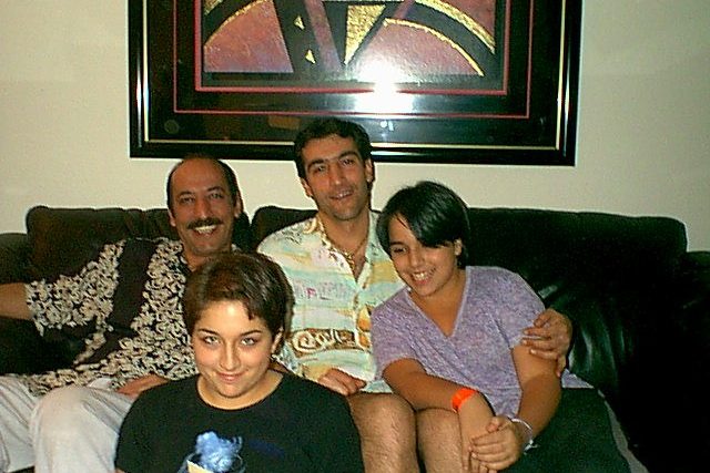 A young Michelle smiles with her family.